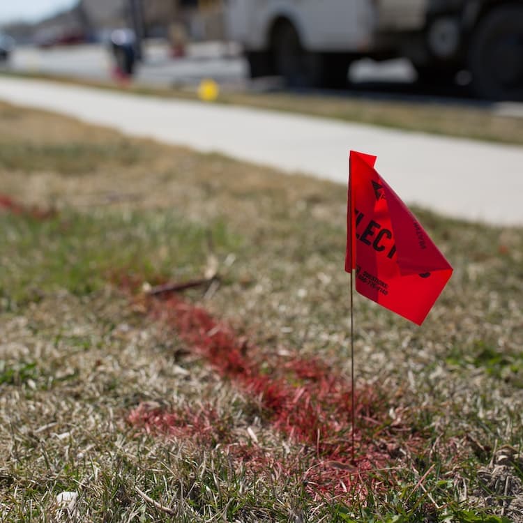 red flag in the ground marking utility lines.