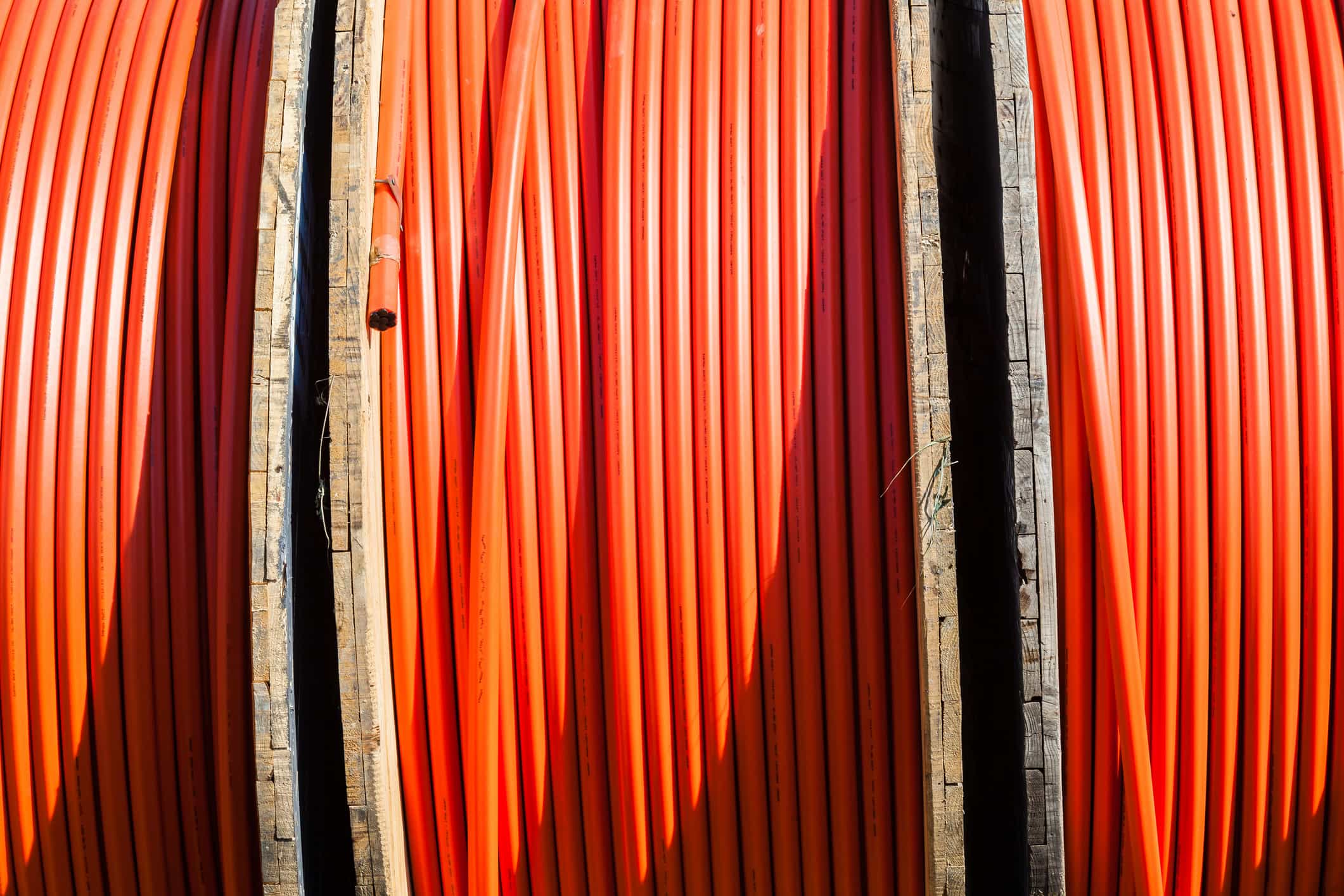 Layered Orange fiber conduit spool.